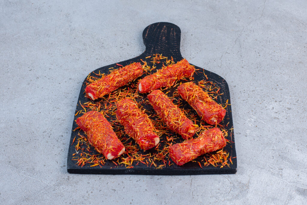 Sprinkled candy coating on Turkish delights on a board, on marble background